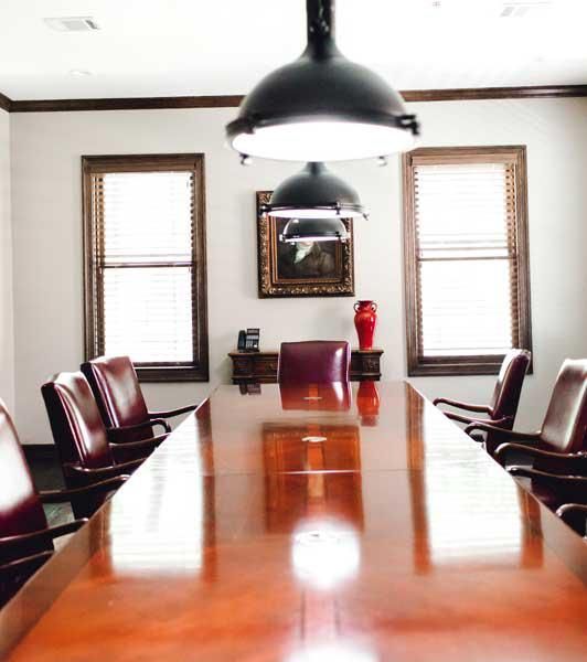 A conference room with a long wooden table and chairs