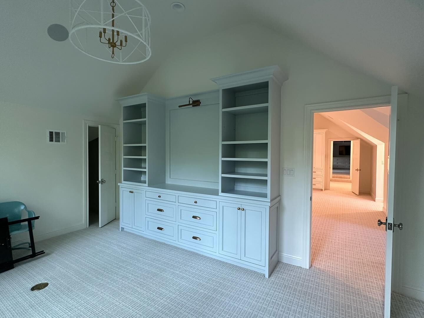 There is a large entertainment center in the middle of the room.