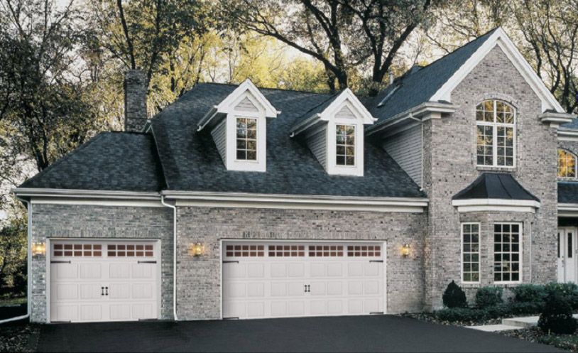Large Brick House With Garage Doors And A Black Roof - Flagstaff, AZ - Loren Vickers