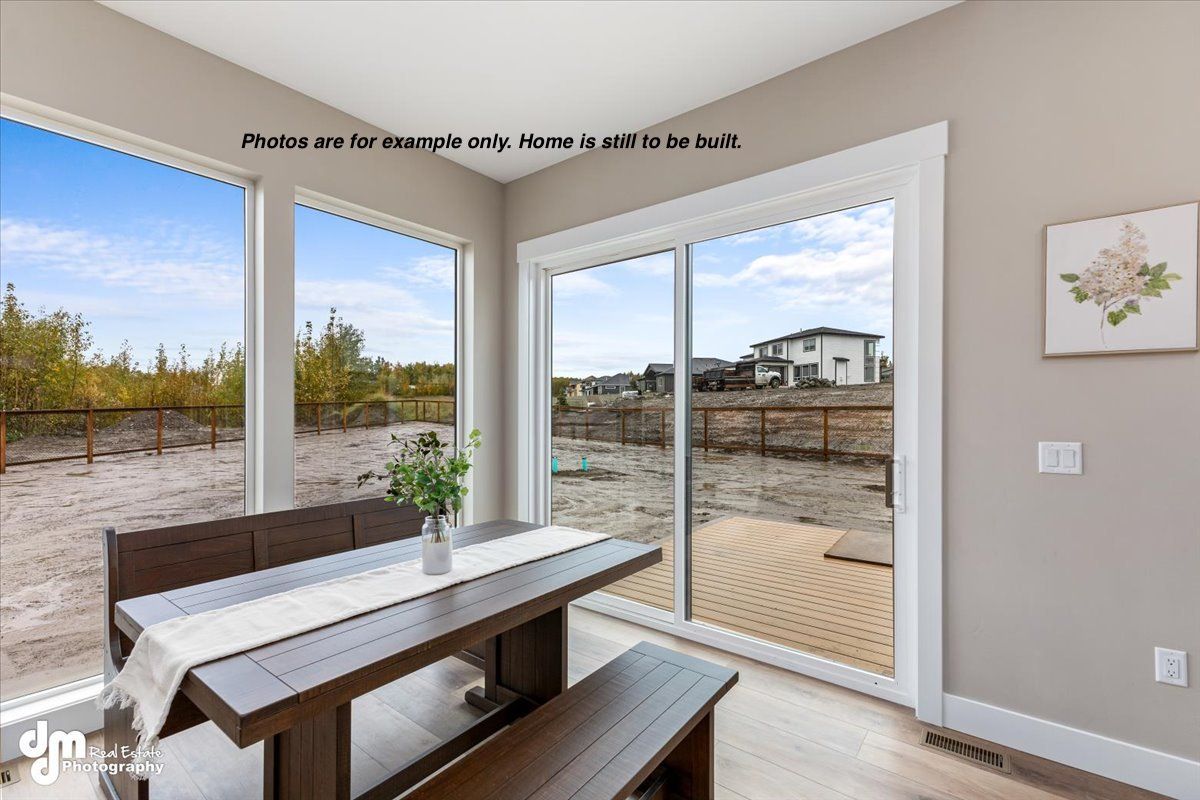 Bright dining area with corner windows, wood table, and outdoor patio view