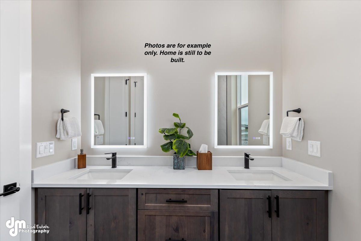 Double vanity bathroom with dark wood cabinets, white countertops, and twin mirrors above sinks