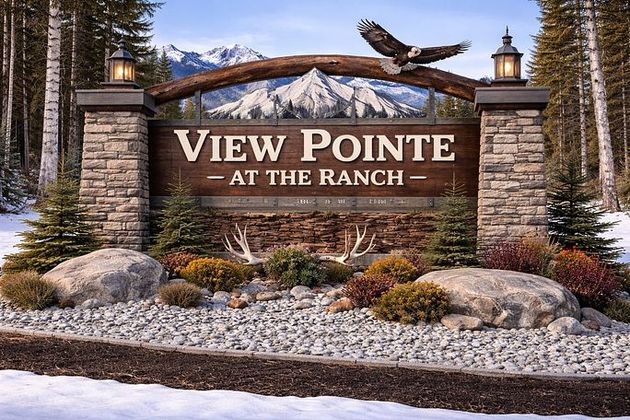 Stone entrance sign reading “View Pointe at the Ranch” with landscaped shrubs, rocks, and mountains behind it