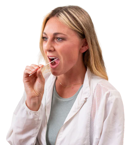 Woman in lab coat uses a swab to collect a sample from her mouth.