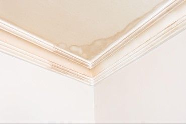 Interior ceiling water stain from residential roof wind damage in Atlanta, Georgia.