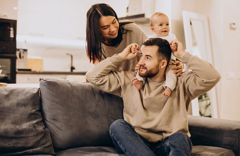 Smiling family with their baby at home
