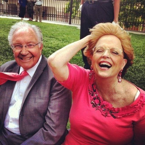 couple sitting on bench laughing