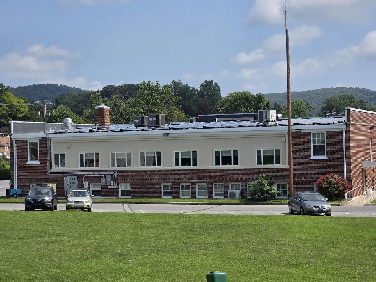 Low-rise brick building with multiple windows. 