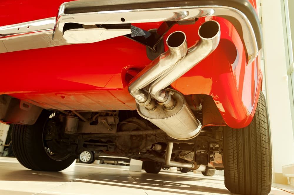 The Exhaust Pipes of A Red Car Are Visible — Andy's A1 Auto Care in Barrack Heights, NSW