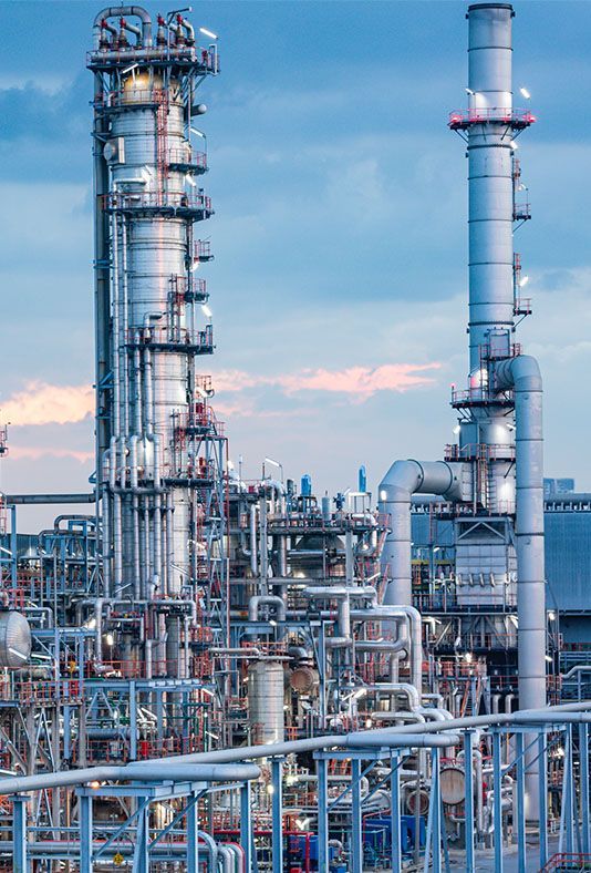 a large oil refinery with a lot of pipes and chimneys .