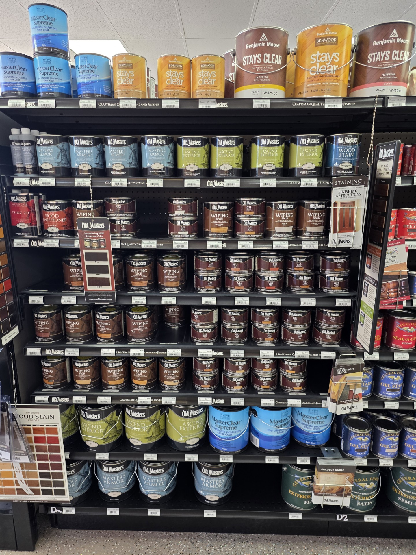 Hardware store aisle with shelves of boxed insulation and stacked paper bags