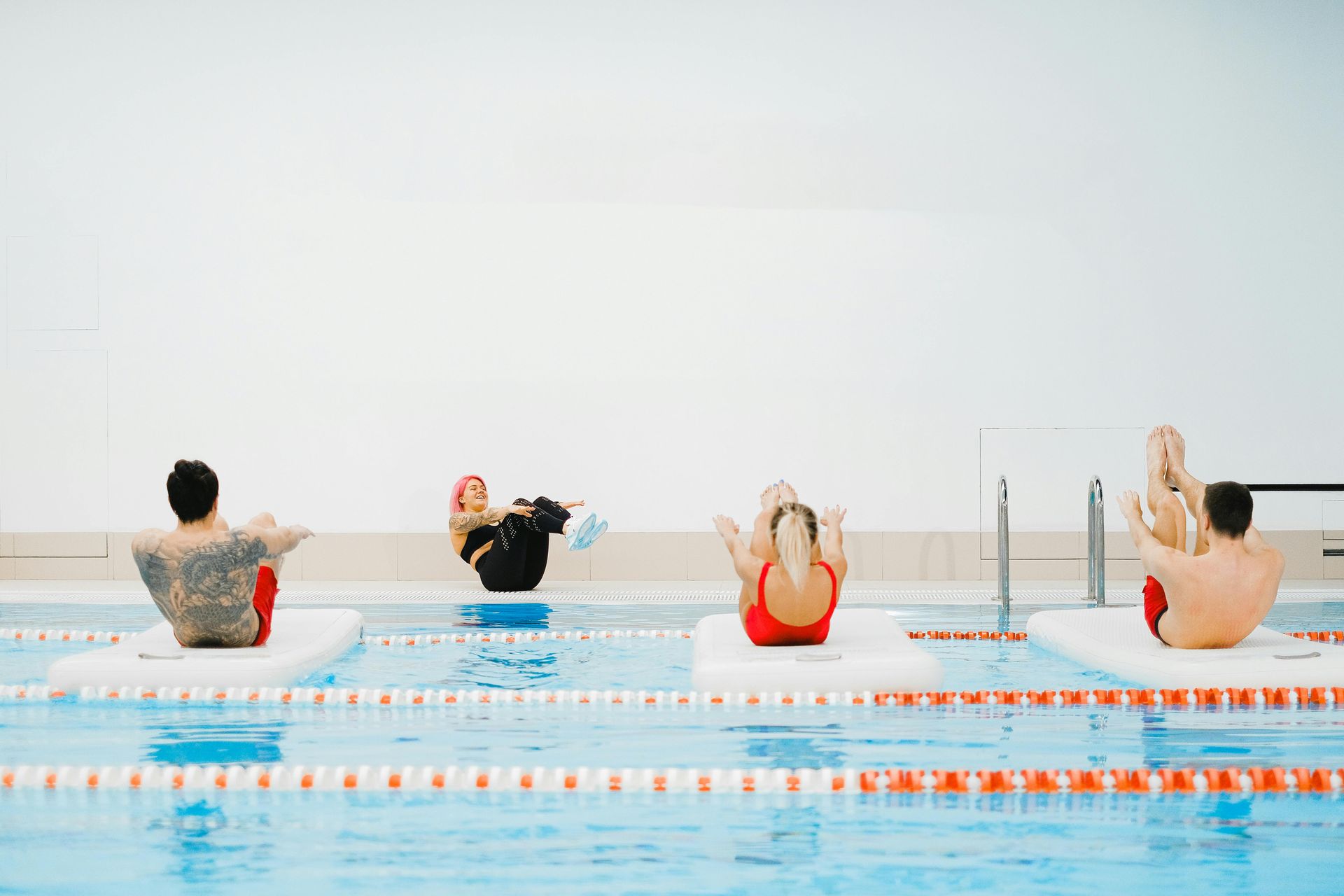 A group of people are doing exercises in a swimming pool.