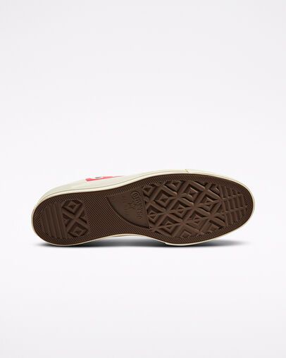 Bottom view of a Converse Chuck 70 sneaker with a brown rubber sole and cream midsole.