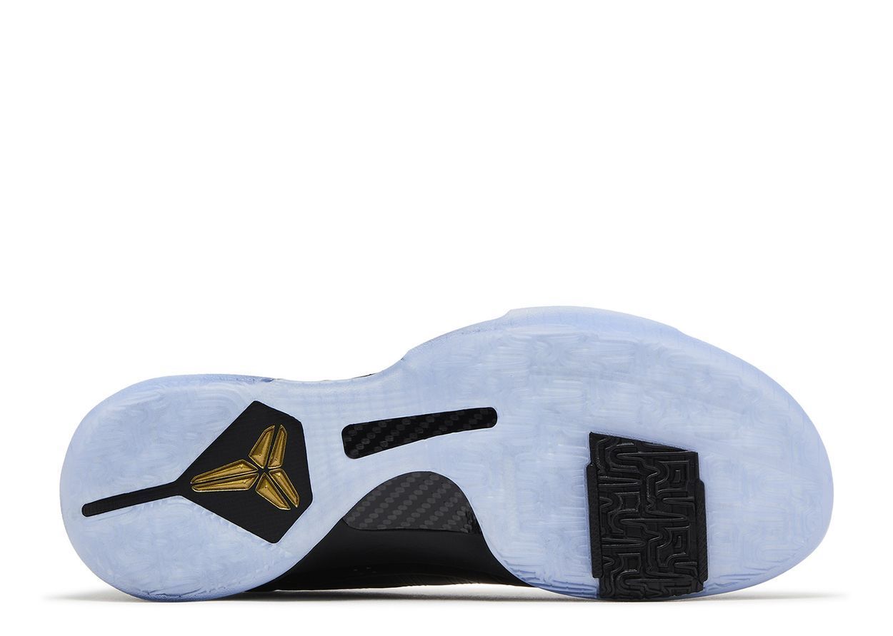 Underside view of a black and light blue Air Jordan shoe, gold Jumpman logo visible.