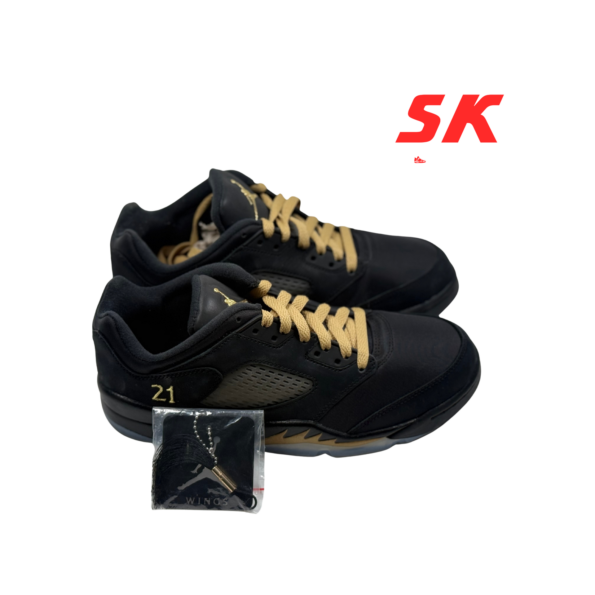 Black and gold Air Jordan 5 Low sneakers with a matching bag on a white background.