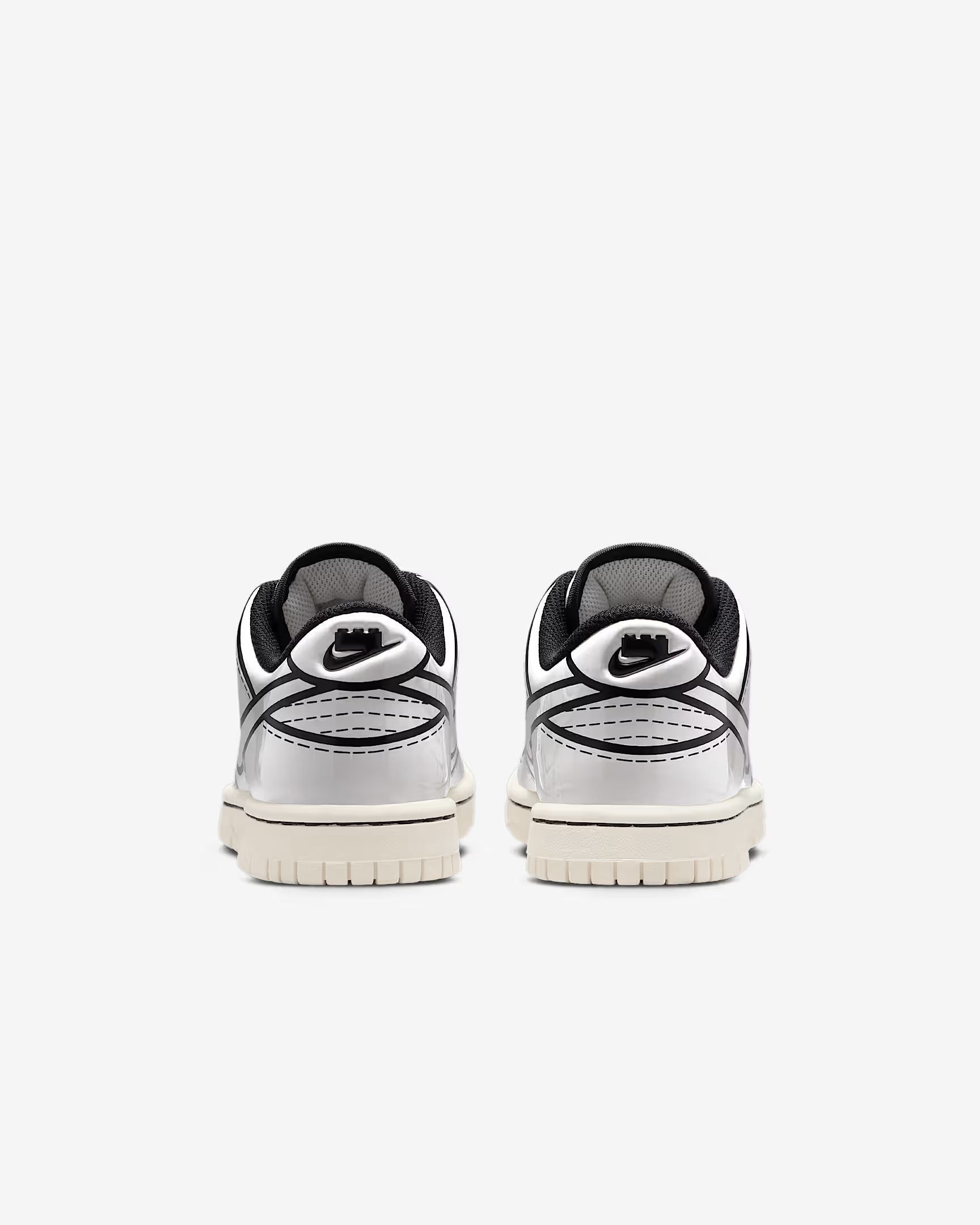 Two Nike Dunk Low sneakers from the back, white with black details.