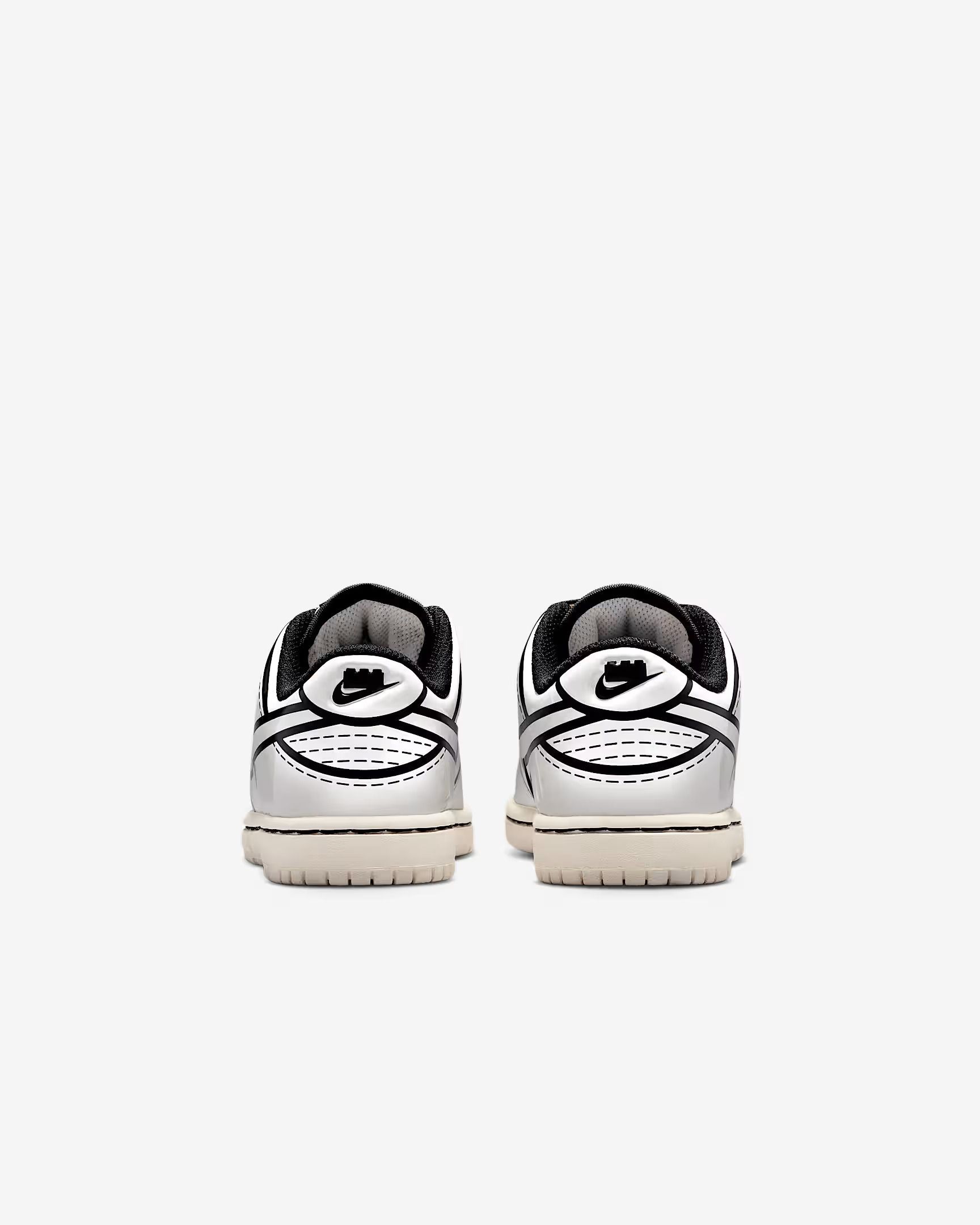 Two white Nike sneakers, rear view, with black accents and cream-colored soles.