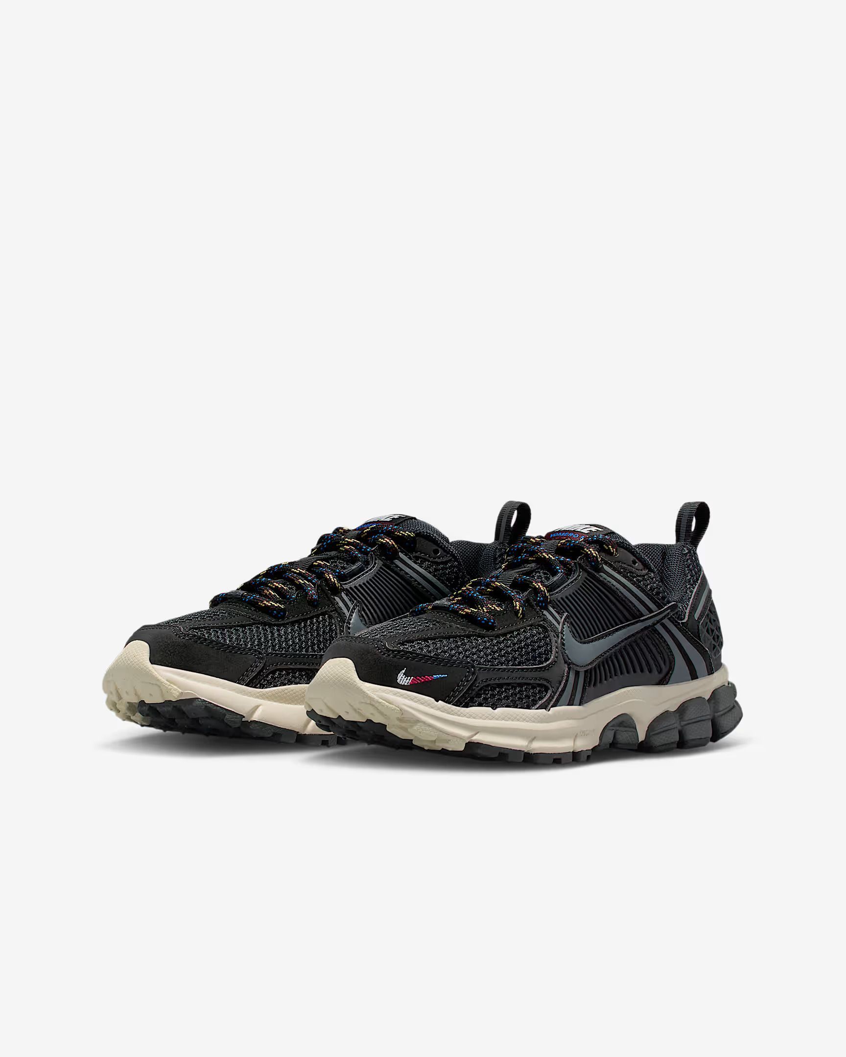 Black and gray Nike sneaker with patterned upper, beige sole, and dark gray accents.