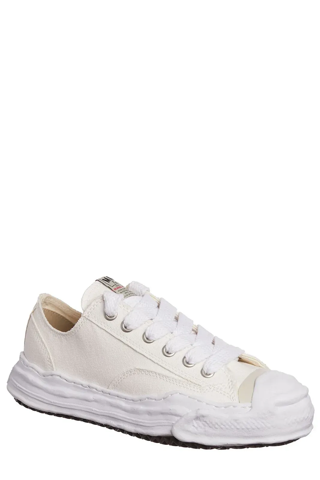White canvas sneakers with a distressed rubber sole.