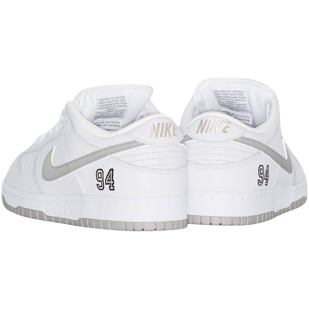 White and gray Nike SB Dunk Low sneakers, with