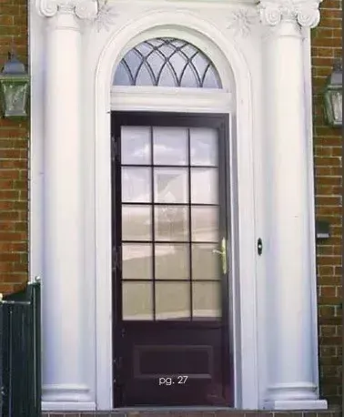 Black front door framed by white columns and an arched window over a brick entryway. Black front door framed by white columns and an arched window over a brick entryway.