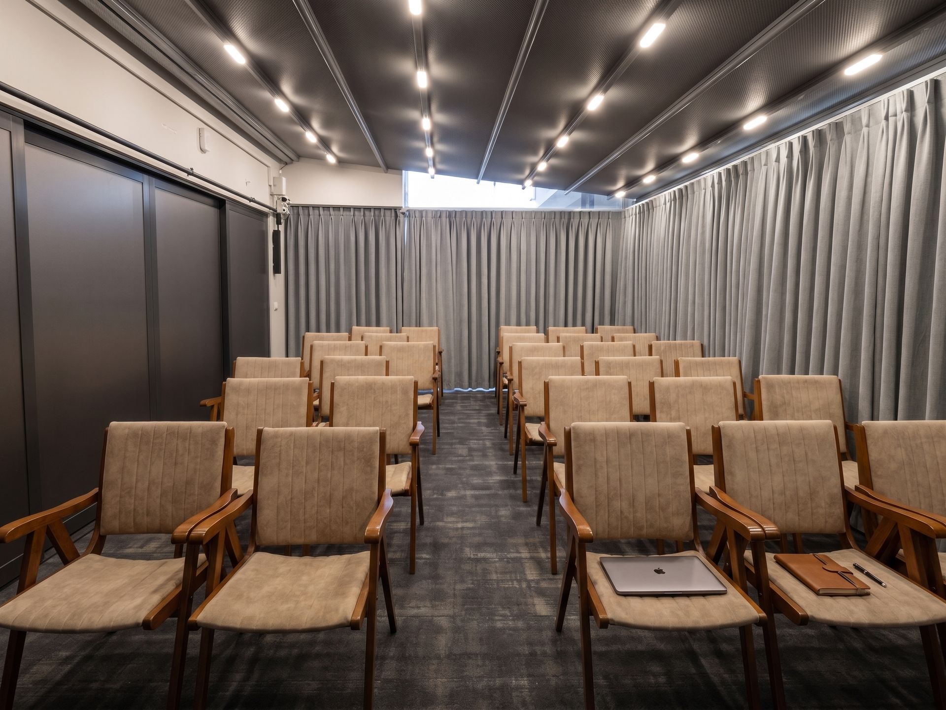 Izz Hotel Koşuyolu | İstanbul |Empty conference room with rows of tan chairs facing a curtained