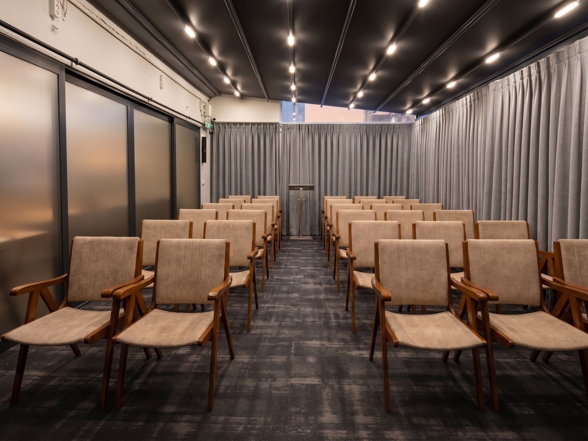Izz Hotel Koşuyolu | İstanbul | Empty conference room with rows of tan chairs facing a curtained wall and dark carpet