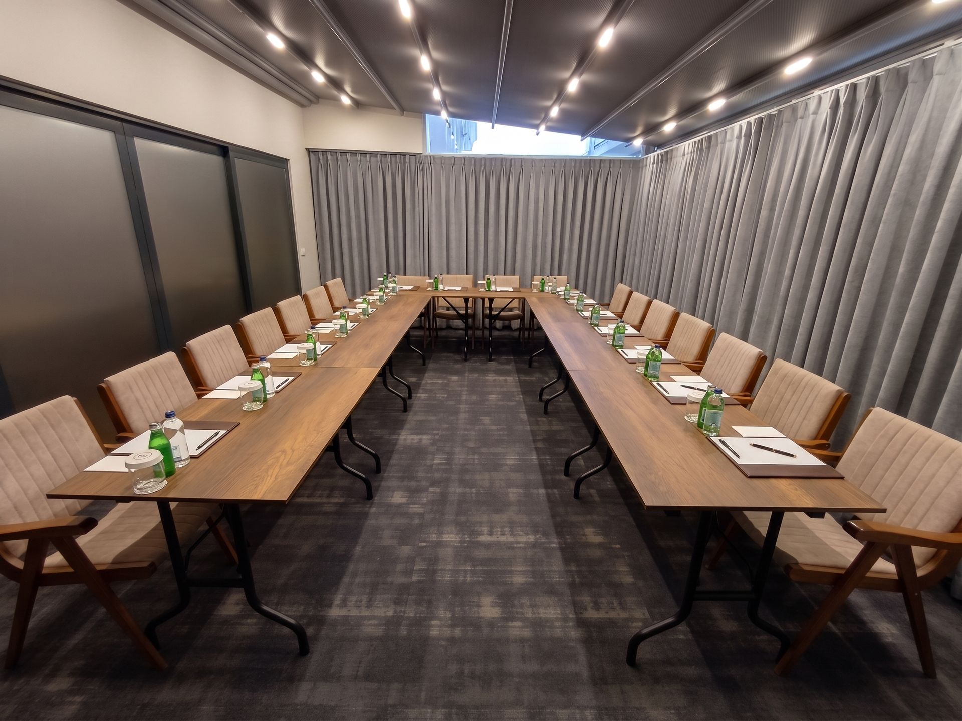 Izz Hotel Koşuyolu | İstanbul | Long conference room with U-shaped tables, chairs, bottles, and papers