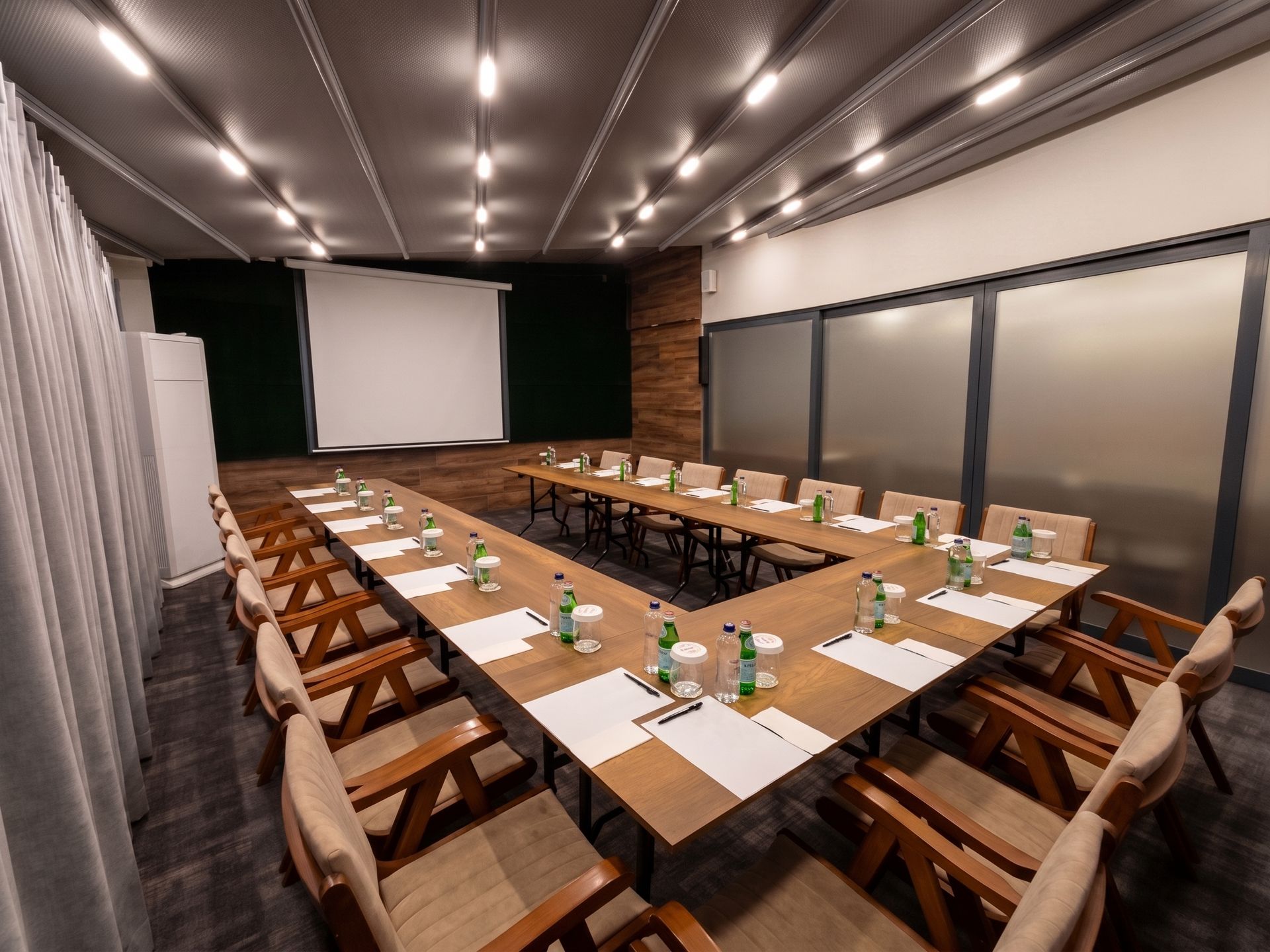 Izz Hotel Koşuyolu | İstanbul | Conference room with a U-shaped table set with papers, bottles, and glasses