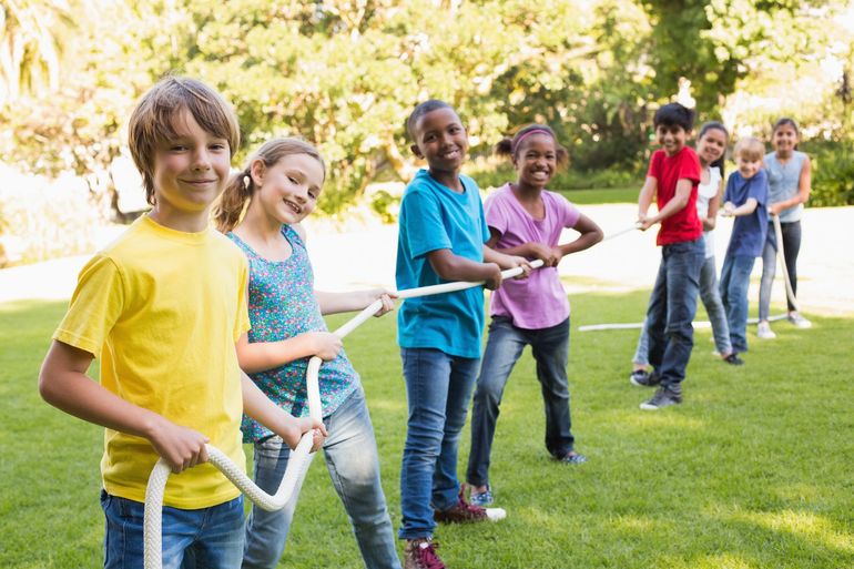 A group of children are playing tug of war
