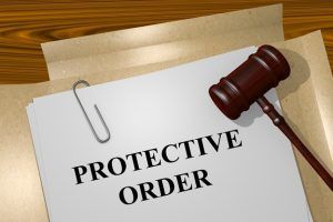 A wooden gavel rests on a paper folder labeled 