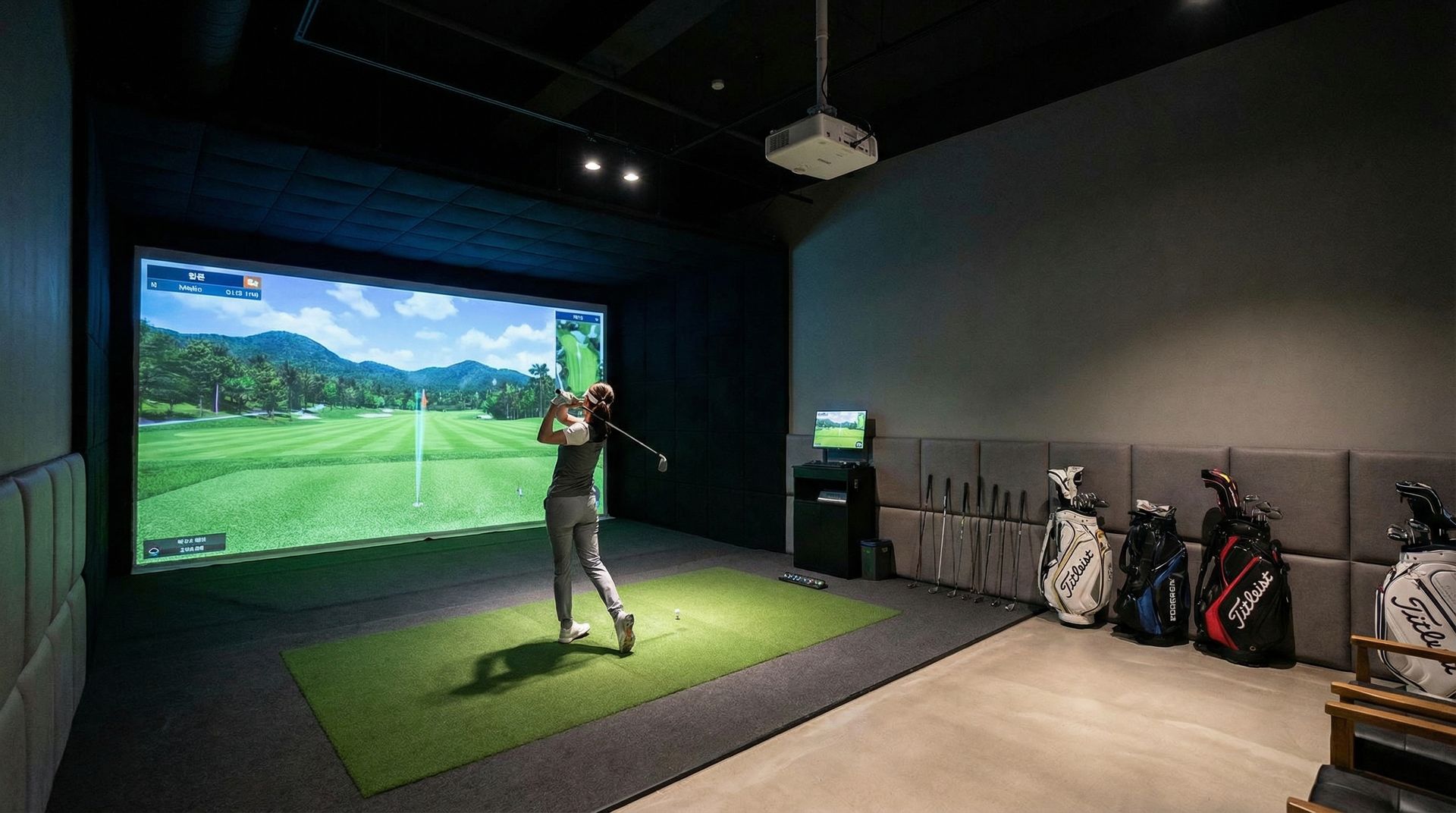 women playing golf in simulator with low lighting