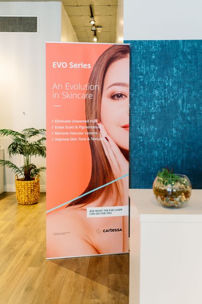 Promotional skincare display with orange and blue panels in a bright retail or salon interior