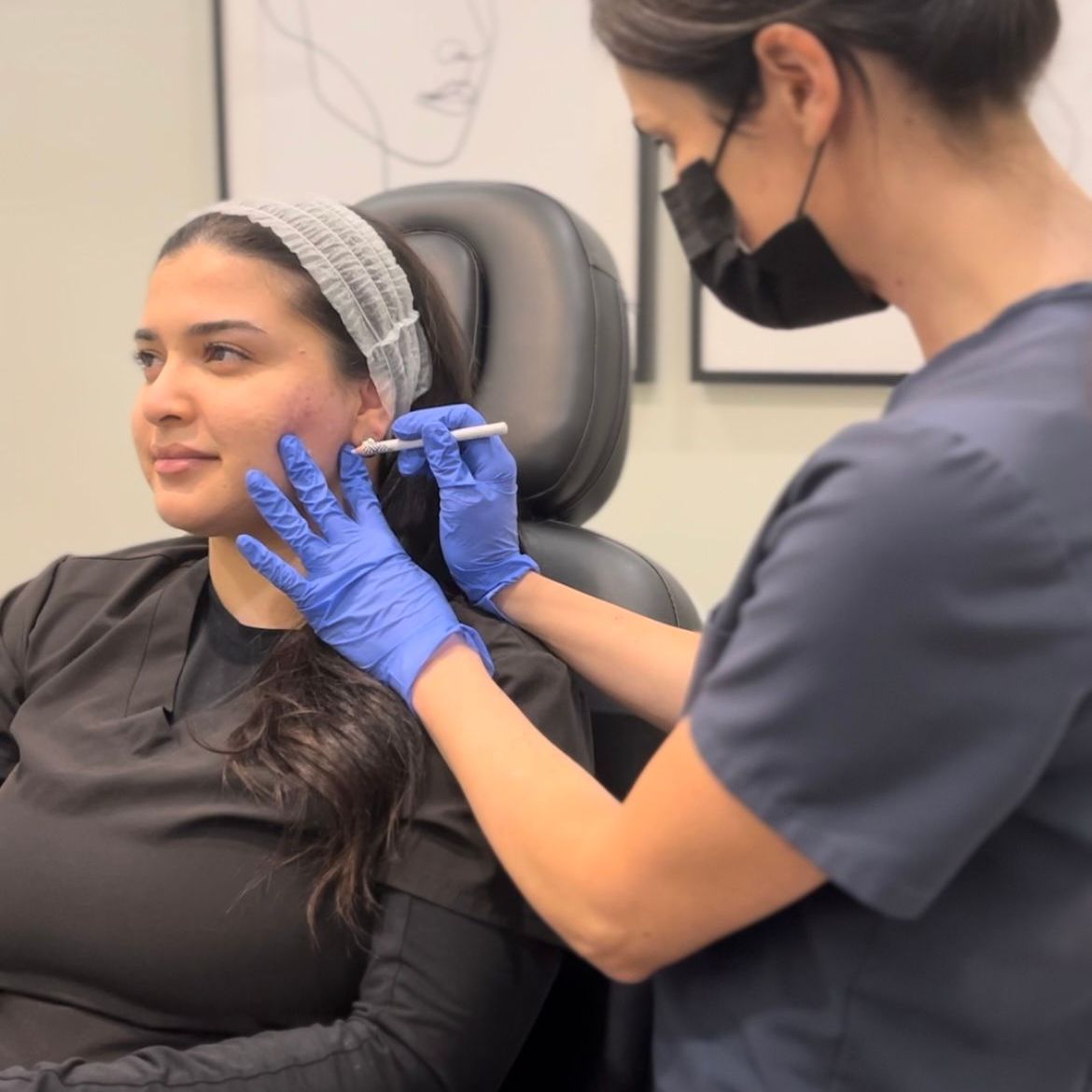 Medical professional injecting filler into a seated patient’s cheek in a clinic