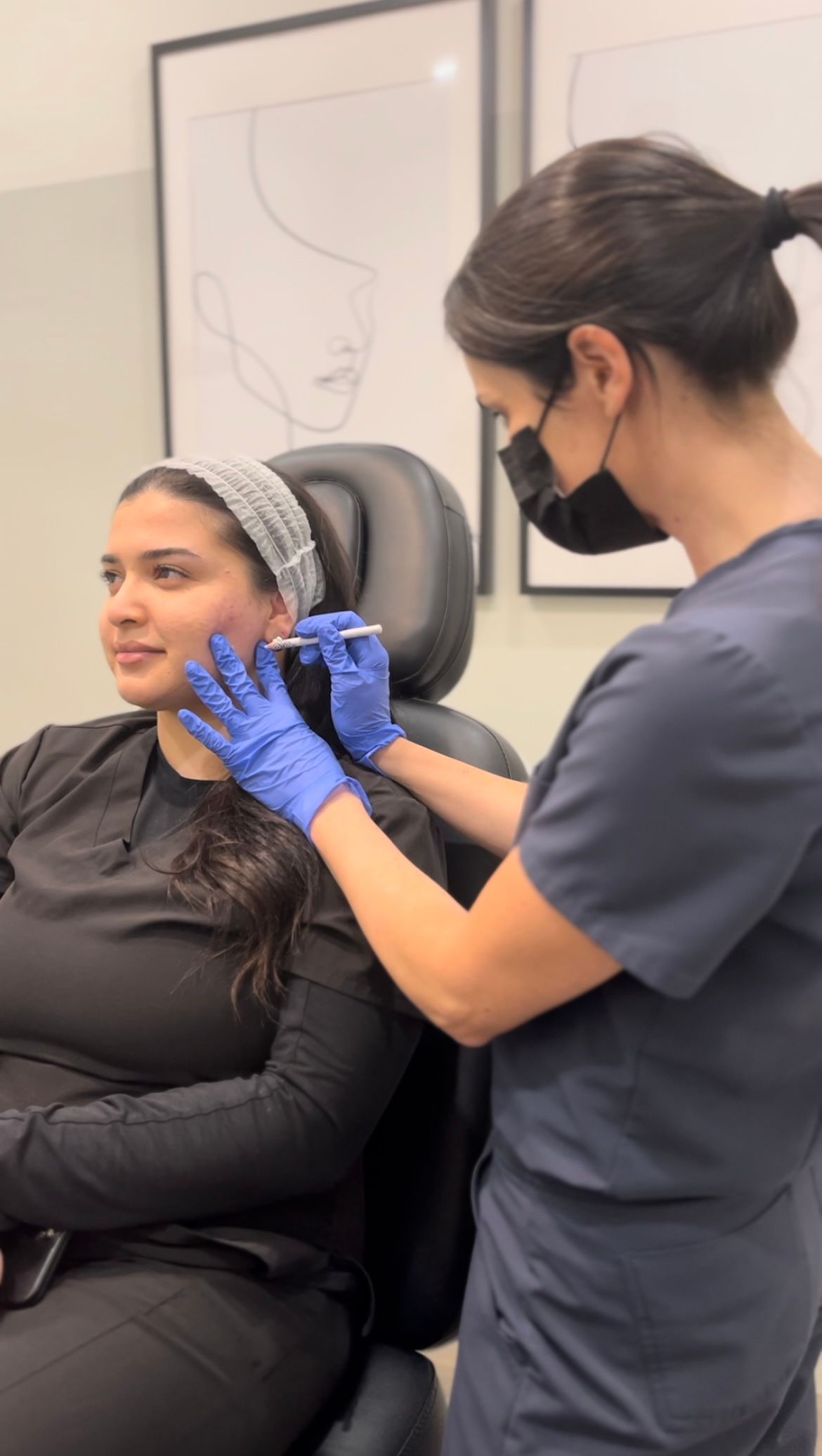 A woman is getting an injection in her face while wearing a mask and gloves.