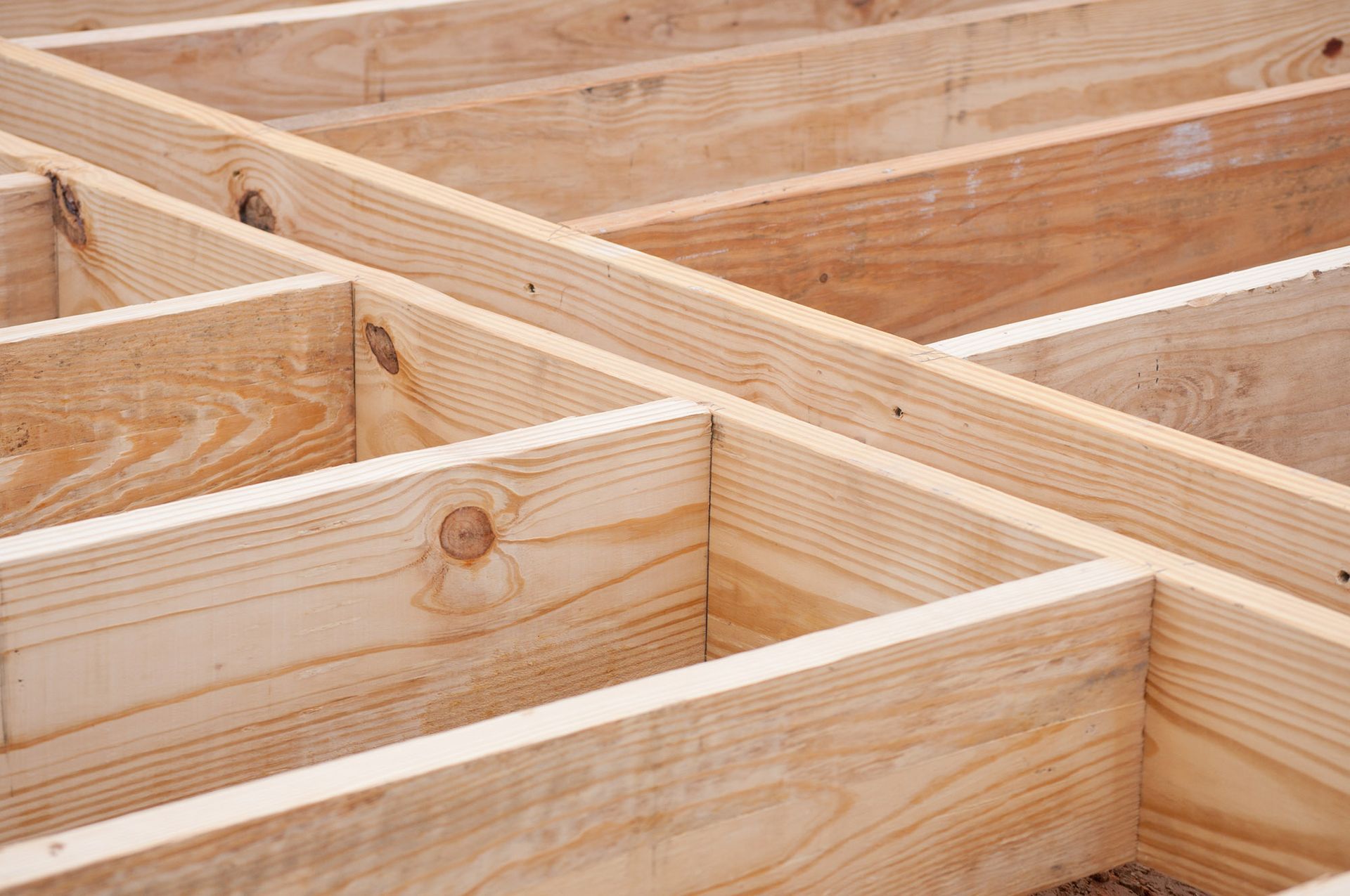 Wooden joists and beams forming the framework of a floor.