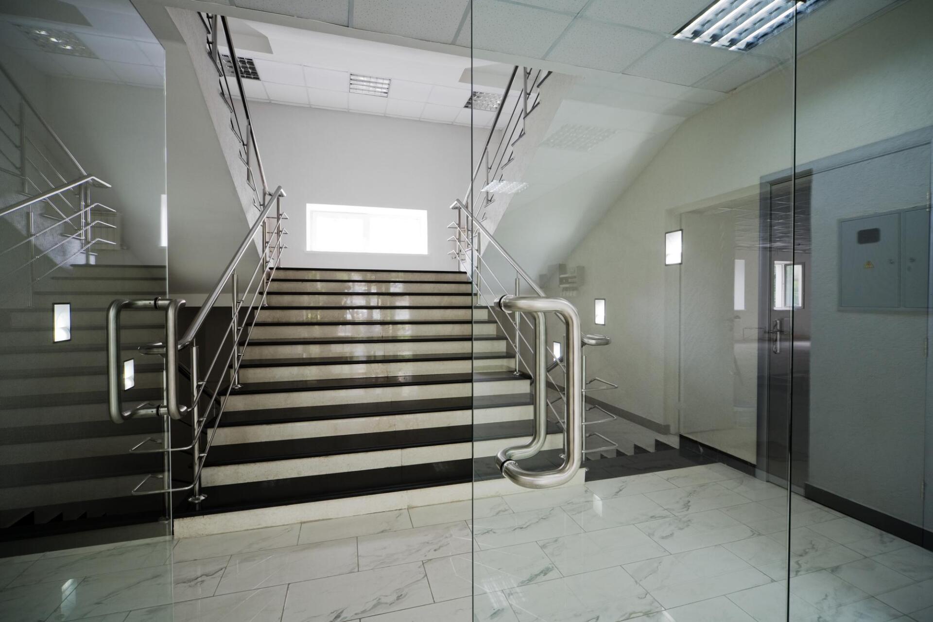 A glass door leads to a set of stairs