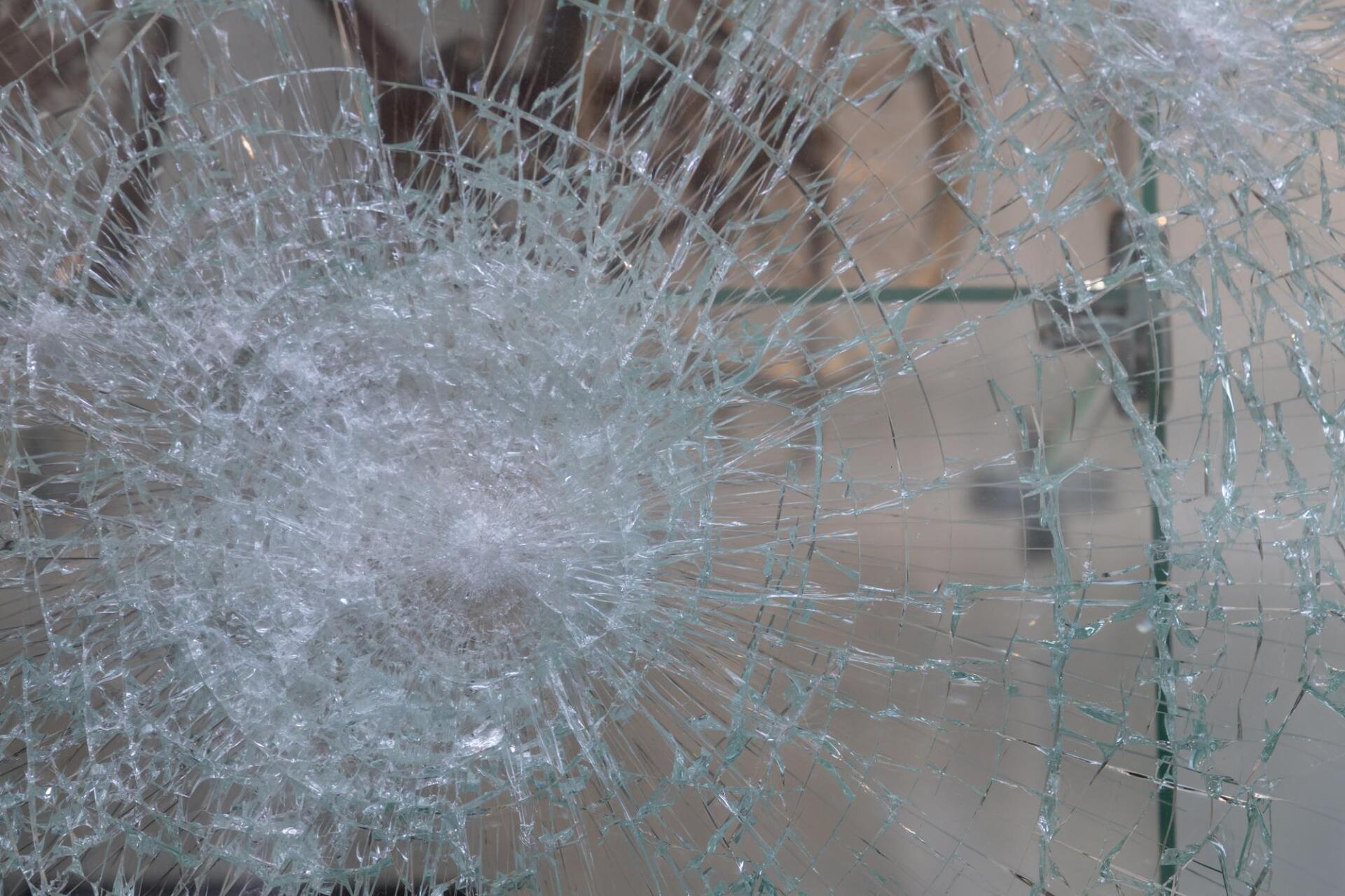 A close up of a broken glass window.