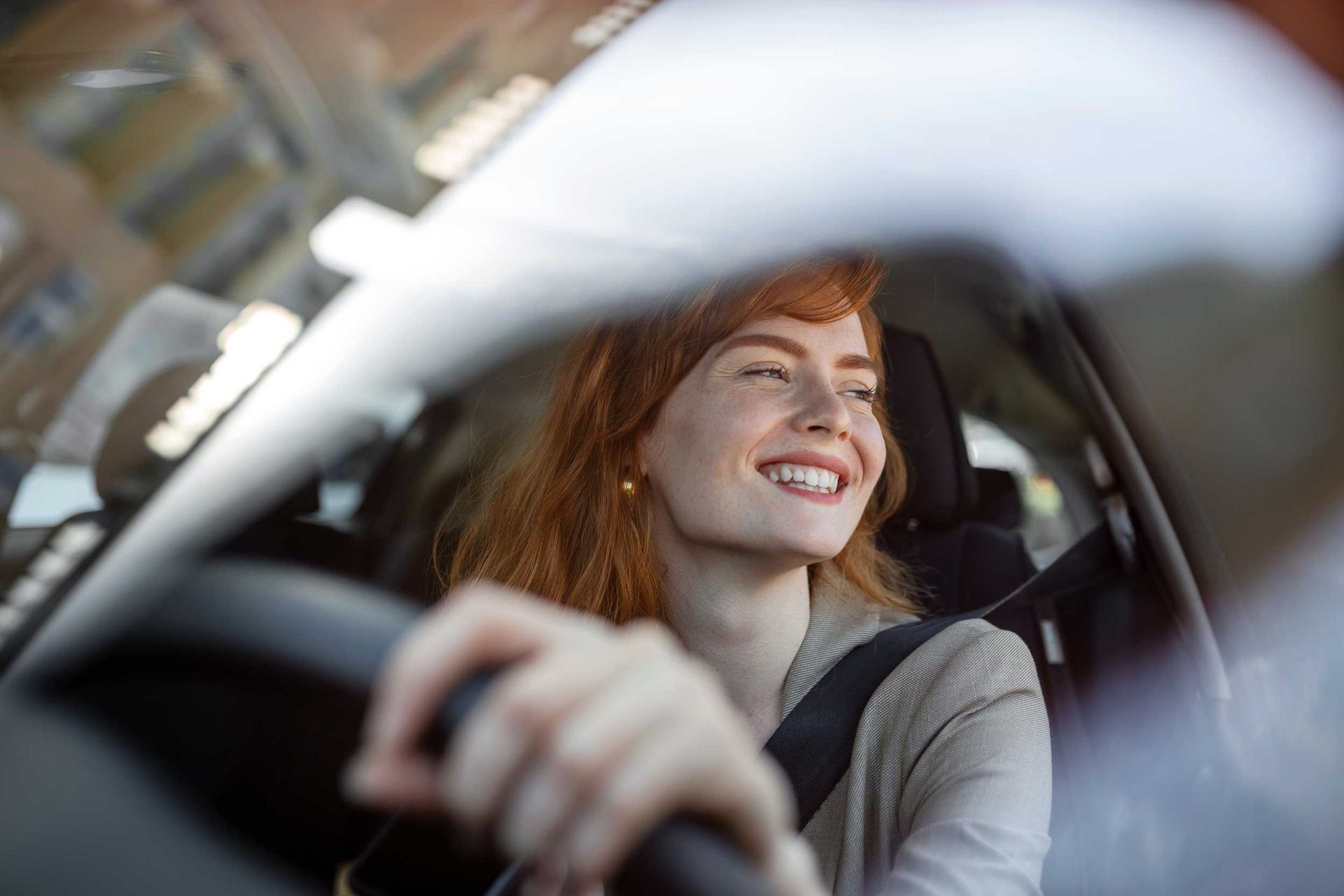 A young woman driving her new car at sunset. A young woman driving her new car at sunset.