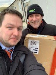 Coview engineer and the delivery man holding the missing router