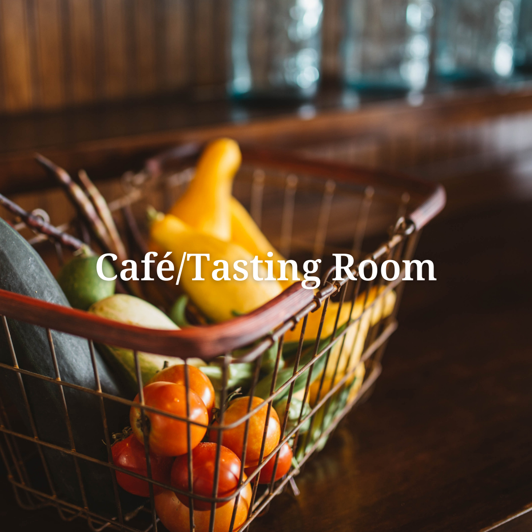 a basket of vegetables with the words cafe / tasting room above it
