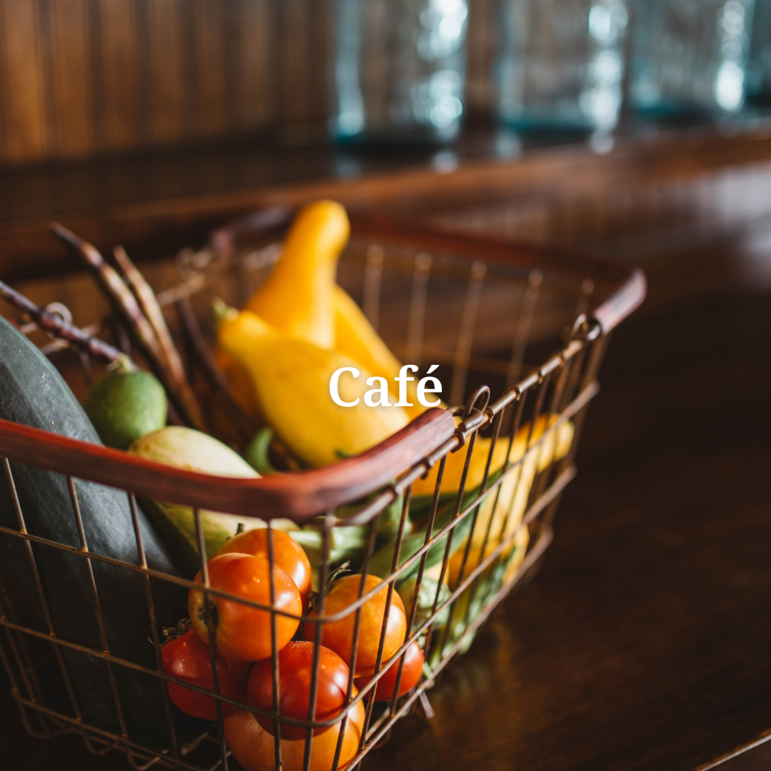 a basket of vegetables with the words cafe / tasting room above it