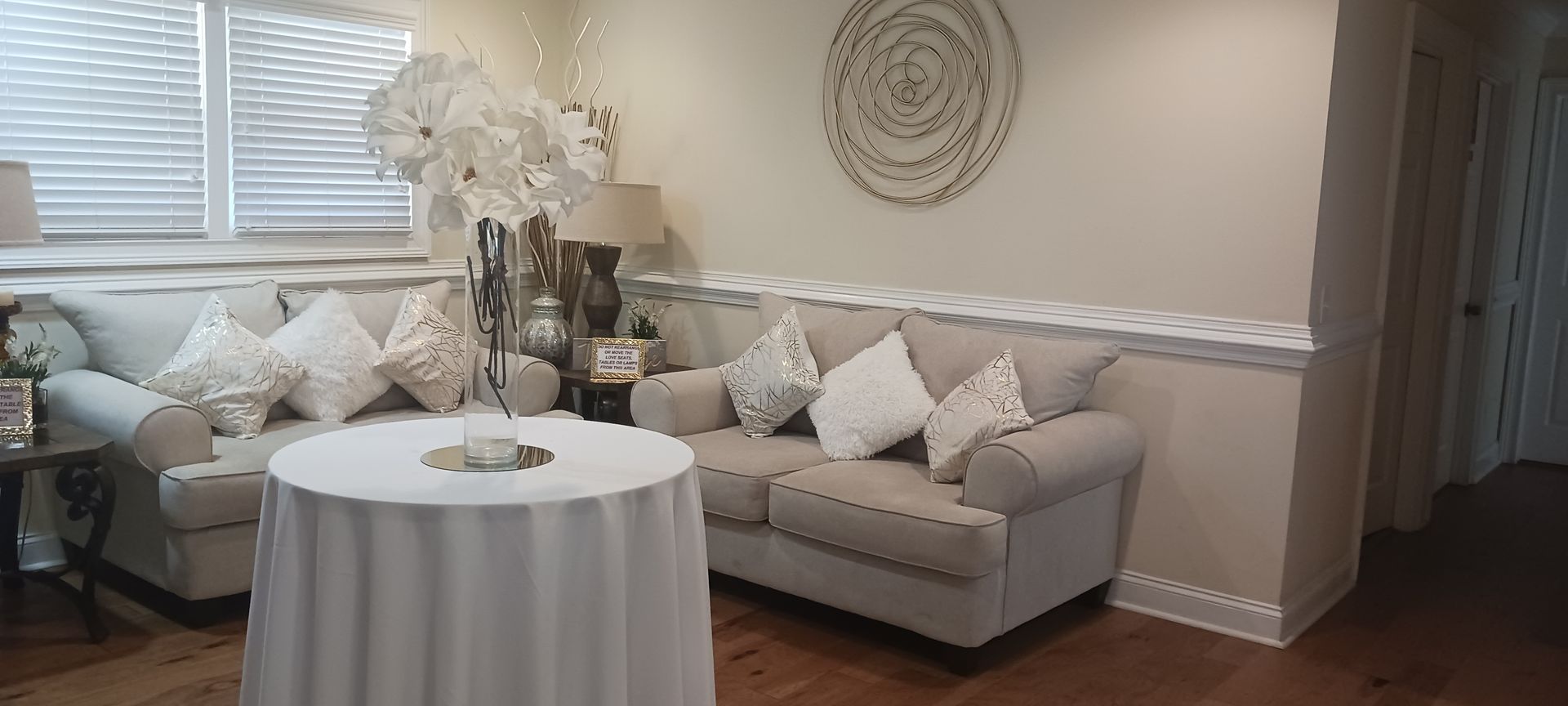 A living room with a couch , table and chairs.