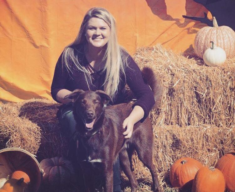 Owner with dog and pumpkins