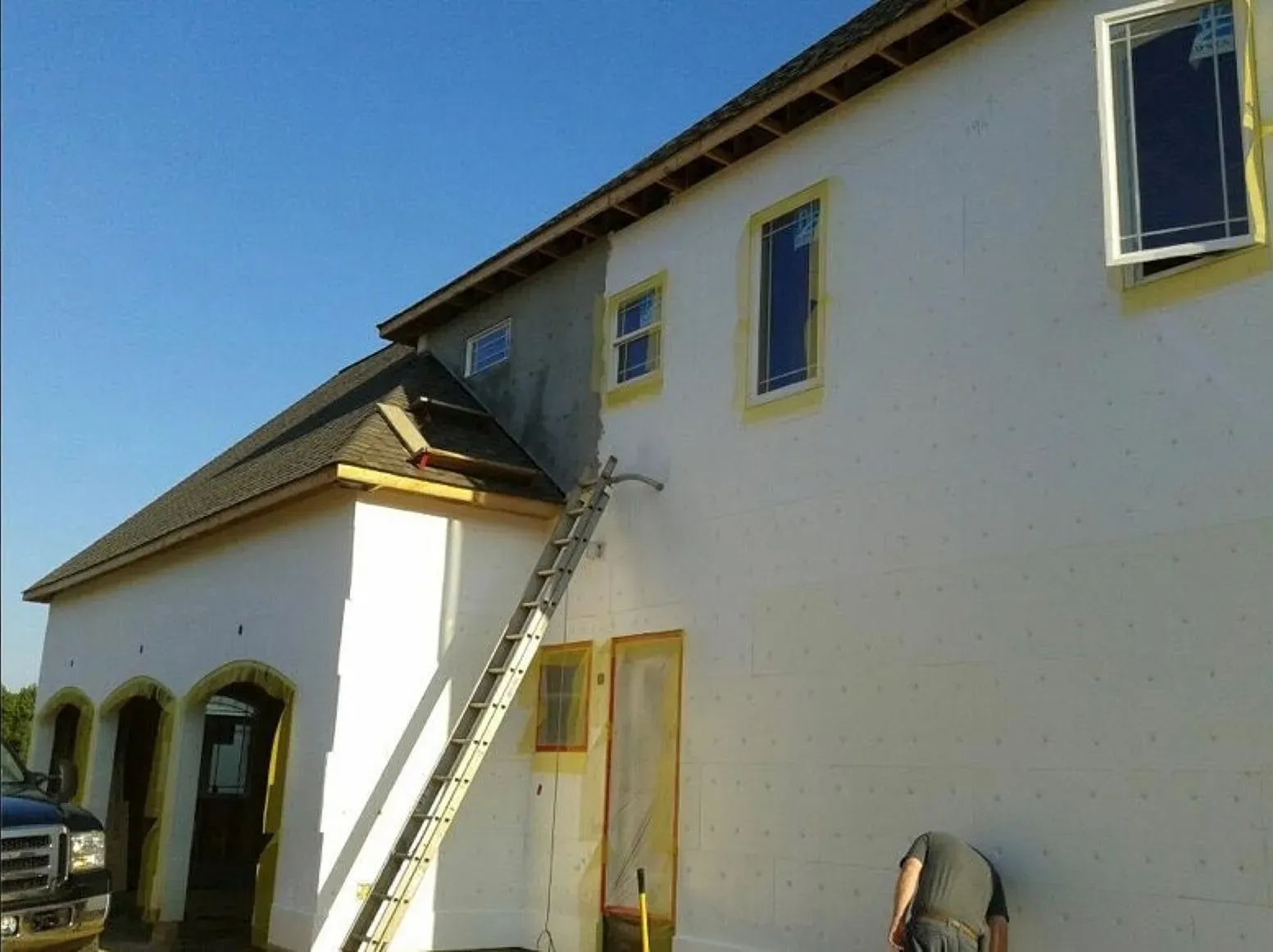 A white building with a ladder on the side of it
