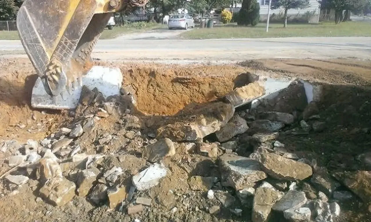 A bulldozer is digging a hole in the ground to prepare for a new foundation. 