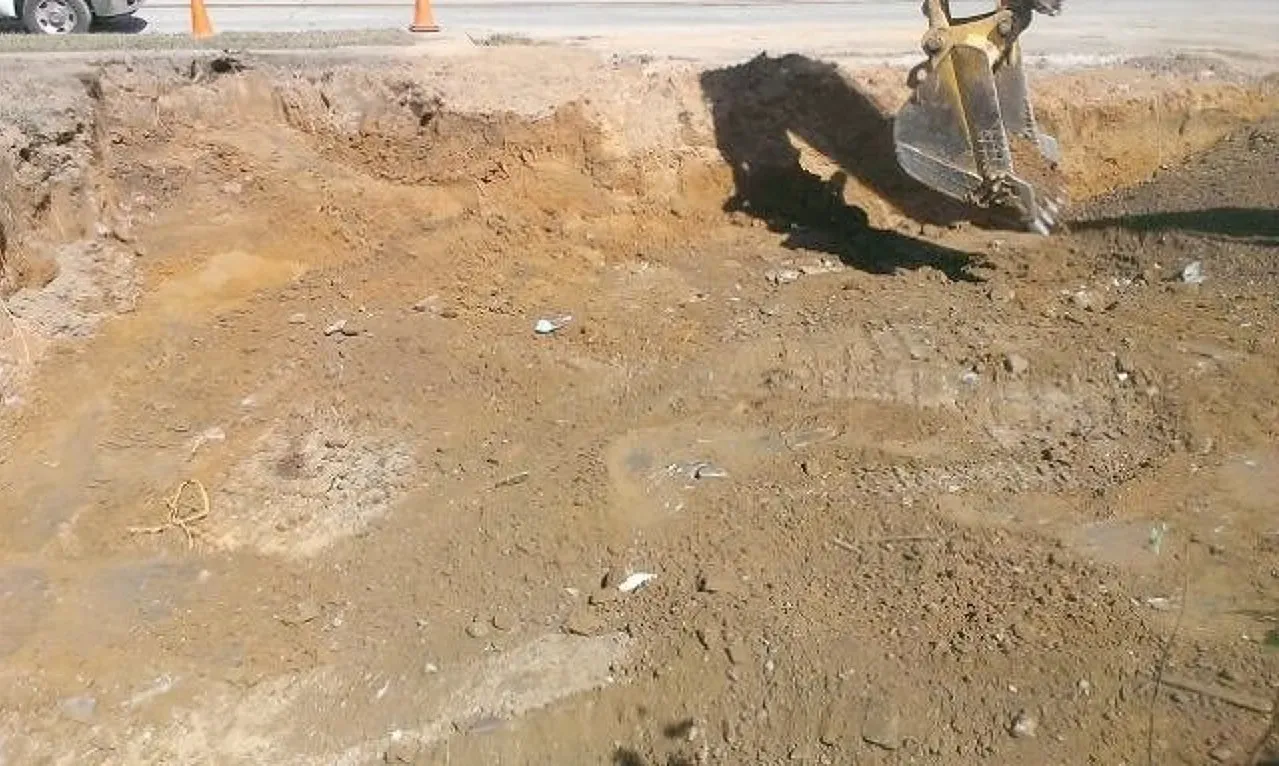 A bulldozer is digging a hole in the ground for commercial excavation in Maryland. 