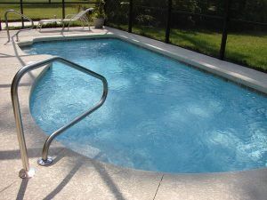 A large in-ground swimming pool filled with water.