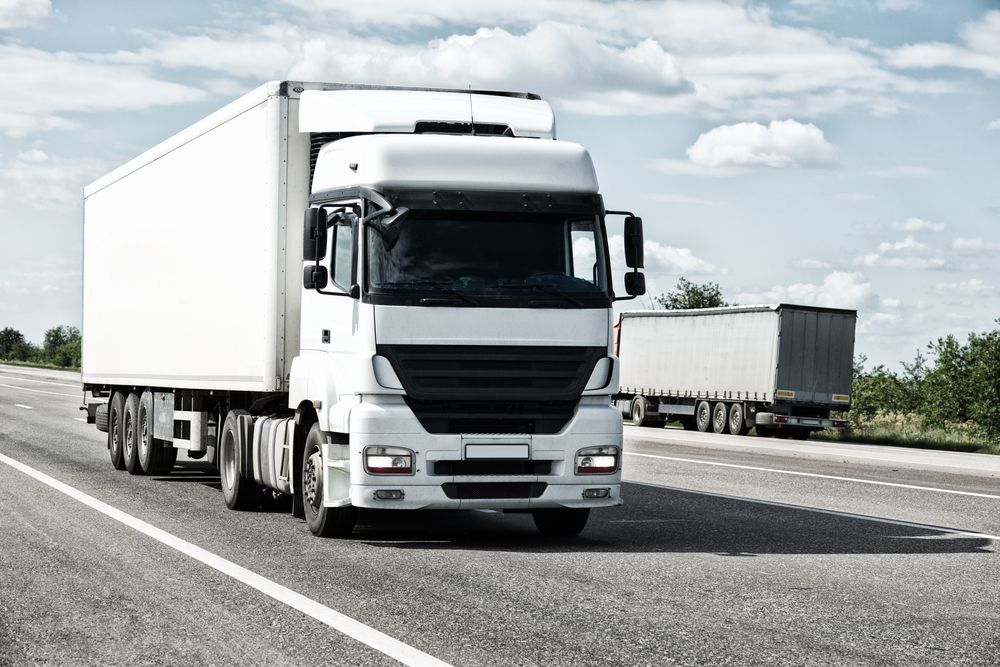 A White Semi Truck is Driving Down a Highway — LJE MechanicaI Dubbo, NSW