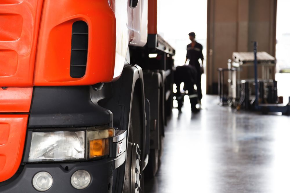 A Man is Working on a Truck in a Garage — LJE MechanicaI  Wellington, NSW