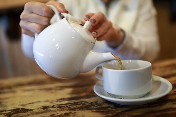Pouring from teapot into a cup